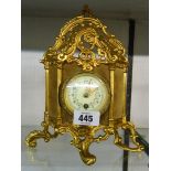 An ornate Rococo style gilt metal and velvet panel cased timepiece with decorative dial and French