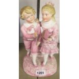 A continental bisque spill vase figure group of a girl and a boy