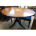 A 4' reproduction mahogany inlaid and cross banded oval tilt-top table with floral motif to top