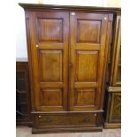 A 4' 2" Edwardian walnut wardrobe with moulded cornice, fielded panelled sides and hanging space