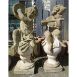 A pair of 3' 4" tall garden statues of putti sat atop finials, one with a flute the other a pair