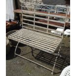 A metal folding two seat garden bench