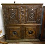 A 3' 11" 19th Century French carved oak corner cupboard with moulded top, repeat floral decoration