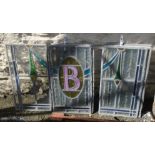 A set of ten leaded glass panels with swag, flower and B motif - various condition