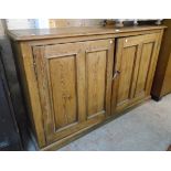 A 5' 10" Victorian pitch pine book cabinet base with shelves enclosed by a pair of panelled doors,