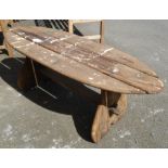 An oval topped elm slatted garden table