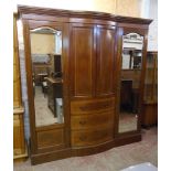 A 6' 6" Edwardian inlaid mahogany break bow front wardrobe with moulded dentil cornice, central