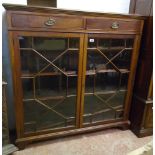 A 4' late Victorian mahogany book cabinet with moulded top, two frieze drawers and adjustable