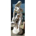 A 4' 4" tall garden statue of a Classical female figure leaning on a tree stump