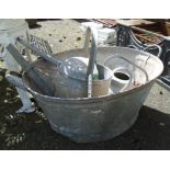 A galvanised tin bath and two watering cans