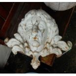 A 16" Victorian painted cast iron fountain head in the form of a female mask with flanking scrolls