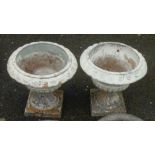 A pair of small painted terracotta two part urn pattern planters