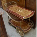A vintage drop sided two tier tea trolley with Sorrento style inlaid marquetry floral decoration and