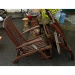 A pair of Barlow Tyrie teak steamer chairs with green cushions