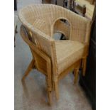 A pair of unpainted wicker tub shaped chairs in the Lloyd Loom style