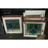 Seven matching painted pine framed leaded lights with coloured stylized tulip decoration