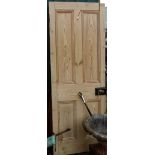 A 2' 6" fielded pine door with brass door knob