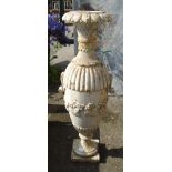 A cast iron slender bulbous pedestal urn of semi-reeded design