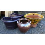 A pair of glazed wall hanging planters - sold with another and an urn style pot