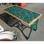 A 3' 10" modern cast iron garden table with rose decoration