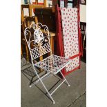 A folding wrought iron garden chair with later white painted finish - sold with two painted wood