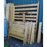 A 4' 6" pine bedstead - sold with a pair of pine single beds