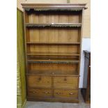 A 3' 11" late Victorian pitch pine bookcase with five open shelves, remains of leather fringing