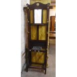 An early 20th Century polished oak hallstand with central bevelled mirror, shelf and marble topped