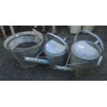 An Apex galvanised watering can - sold with another and two galvanised buckets