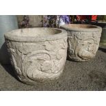 A pair of 15" diameter concrete planters with embossed bird, deer and vine decoration