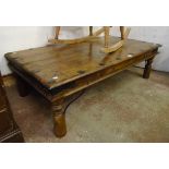 William Sheppee: a 4' 5" iron studded Eastern hardwood coffee table with iron brackets and turned