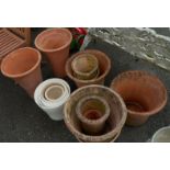 Two pairs of large terracotta plant pots and various other plant pots