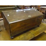 A 29" mahogany slope topped storage box with two drawer fitted interior, set on turned feet