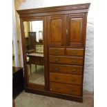 A 5' 3" Edwardian walnut gentleman's wardrobe with moulded cornice, hanging space enclosed by a