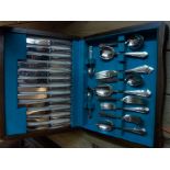 A polished wood canteen containing a six place setting of Bennett & Heron silver plated cutlery