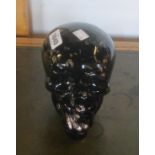 A black and gold glass skull