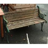 A slatted bench with pierced cast iron ends - a/f