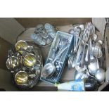 A box containing a quantity of silver plated items including four place egg cruet, part cruet set,