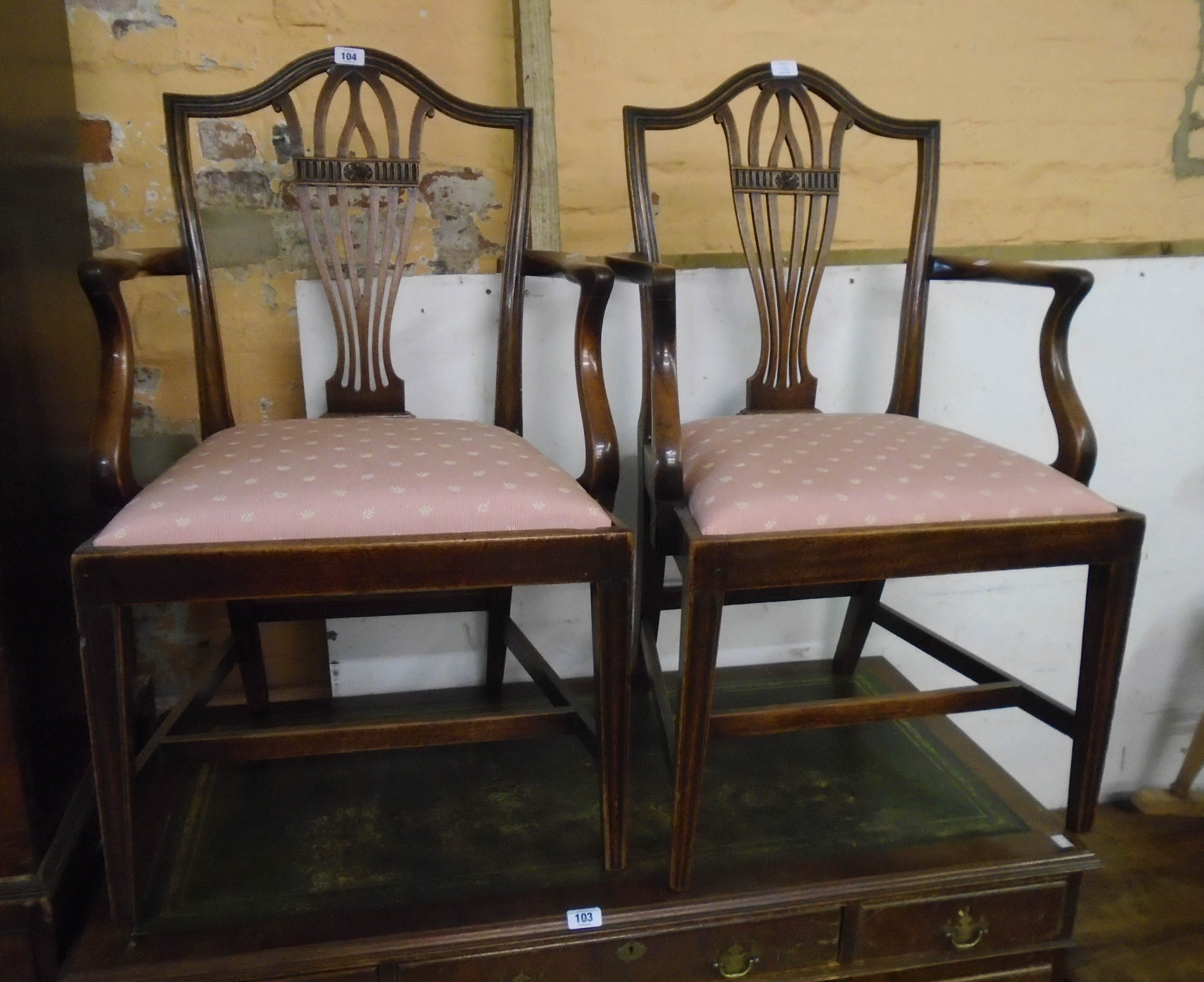 A pair of 19th Century mahogany framed Chippendale style elbow chairs with pierced splats and