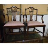 A pair of 19th Century mahogany framed Chippendale style elbow chairs with pierced splats and