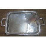 A 17 1/2" silver plated tea tray with applied cast rim, flanking carrying handles and engraved