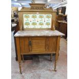 A 33" Edwardian satin walnut washstand with tile set raised back, marble top and cupboard under, set