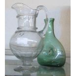 A glass ale jug (a/f) and a green glass carafe