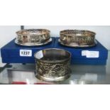 Two boxed silver plated wine coasters, both with pierced rims and polished oak bases - sold with