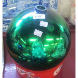 A 10" diameter green glass witch ball