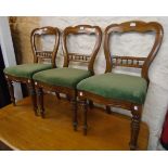 A set of four Victorian mahogany framed balloon back dining chairs with spindle set back rails and