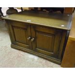 A 30" polished oak low two door cabinet, set on bracket feet