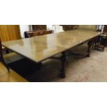 A 10' early 20th Century draw-leaf dining table with bracketed quarter veneered top, set on