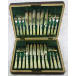 A mahogany cased set of twelve each ornate silver plated dessert knives and forks with mother-of-