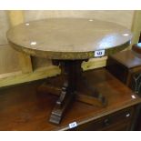 A 23 1/2" diameter Spanish brass topped occasional table, set on polished hardwood Gothic style